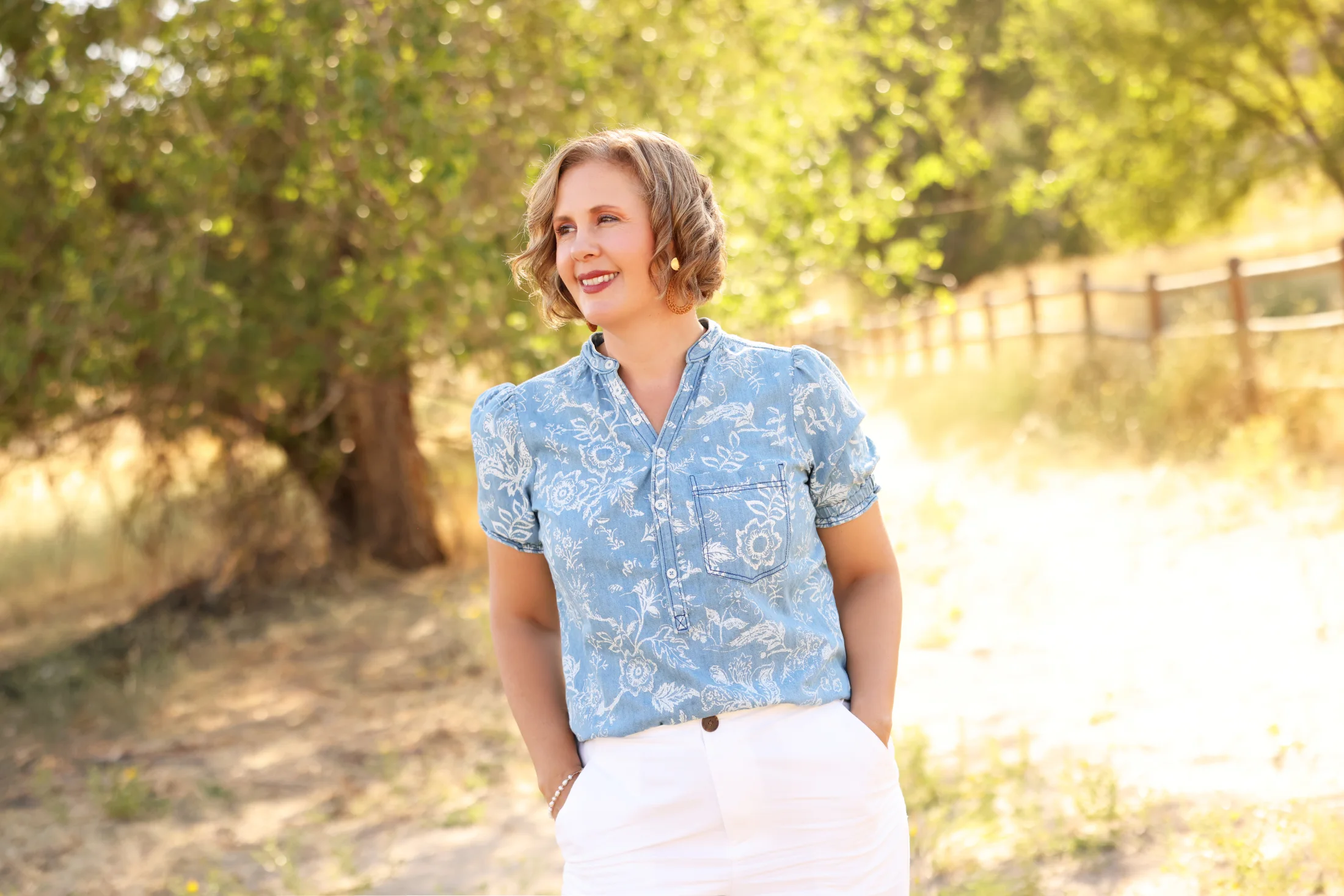 Cacey Klein in a blue floral blouse outdoors in Idaho.